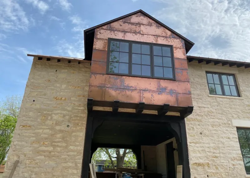 Copper metal panel facade on a stone building for Skylight Installation in Papillion