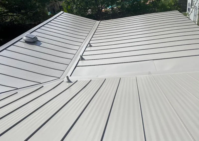 Solar attic fan installed on a metal roof for Roof Ventilation in Papillion